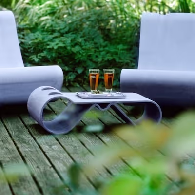 Swisspearl Guhl‑Stühle mit Guhl‑Tisch, darauf zwei Gläser mit rotem Saft und ein Tablett.
